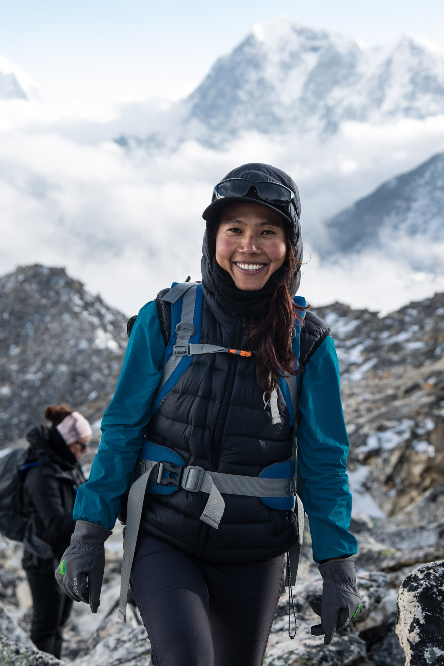 Female model enjoying a hiking day on a mountain wearing a Rainy Days jacket
